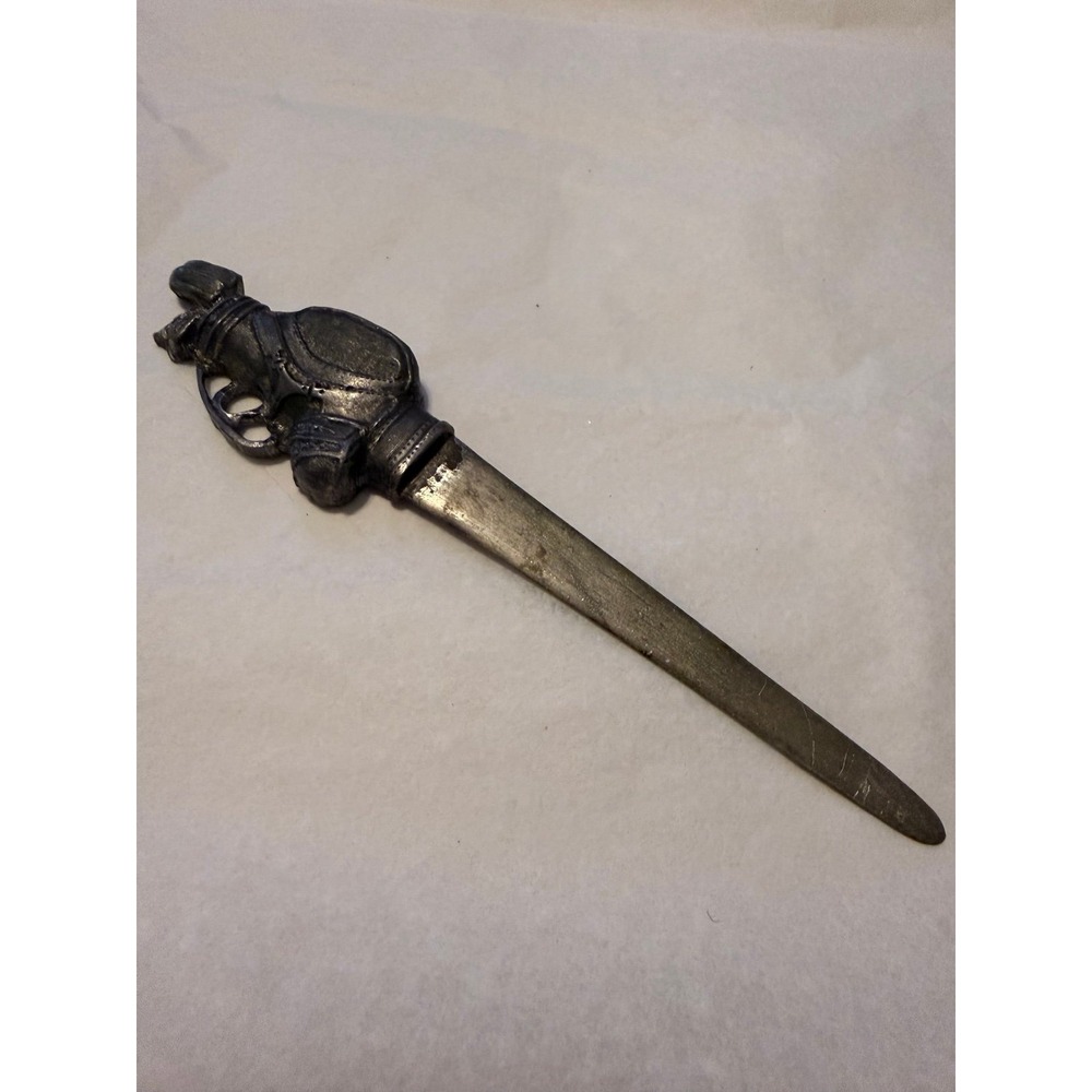 Vintage letter opener featuring a handle shaped like a golf bag with clubs